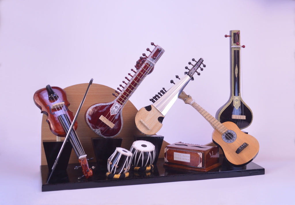 Collection of stringed instruments on a stand with a white background