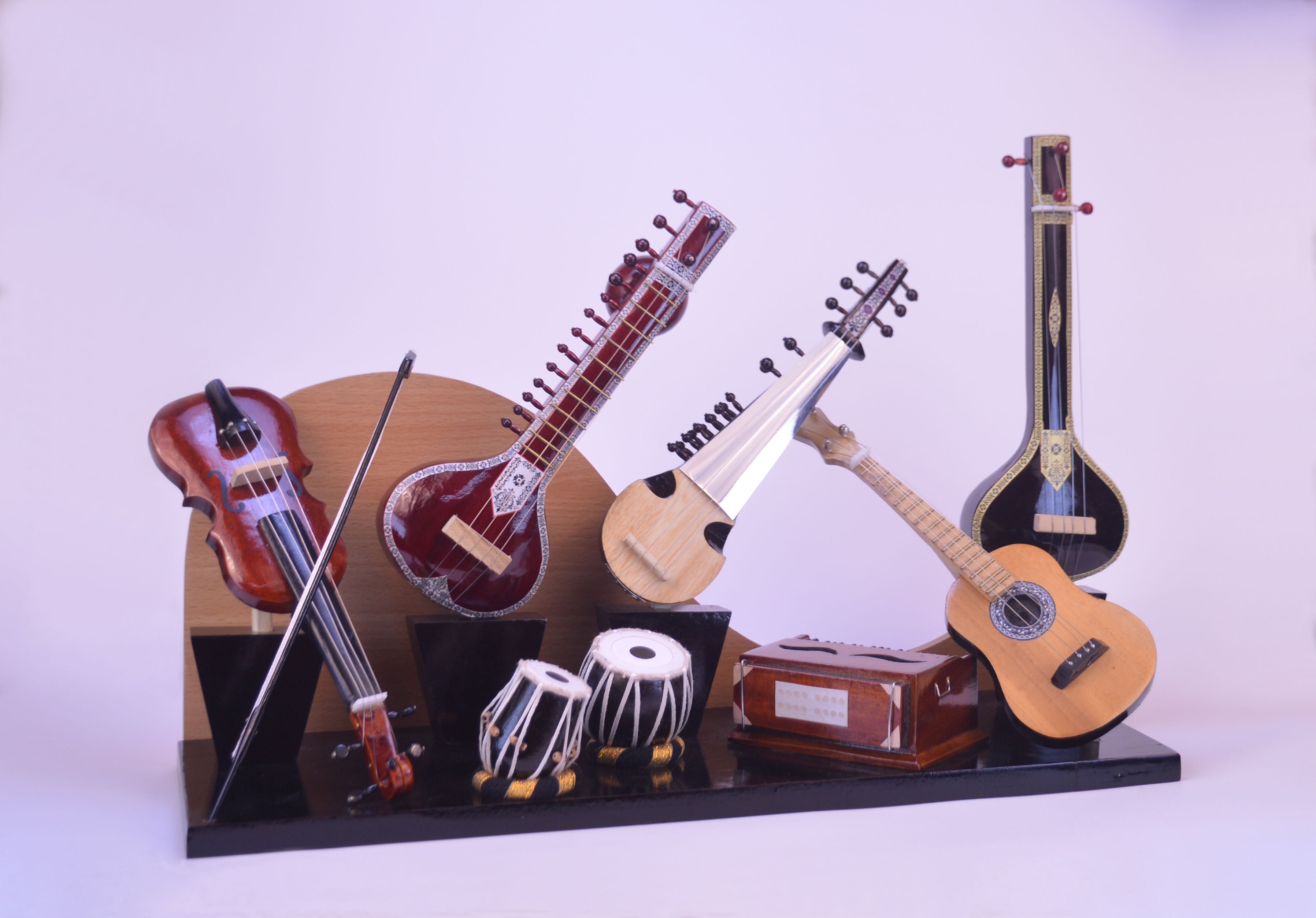 Collection of stringed instruments on a stand with a white background